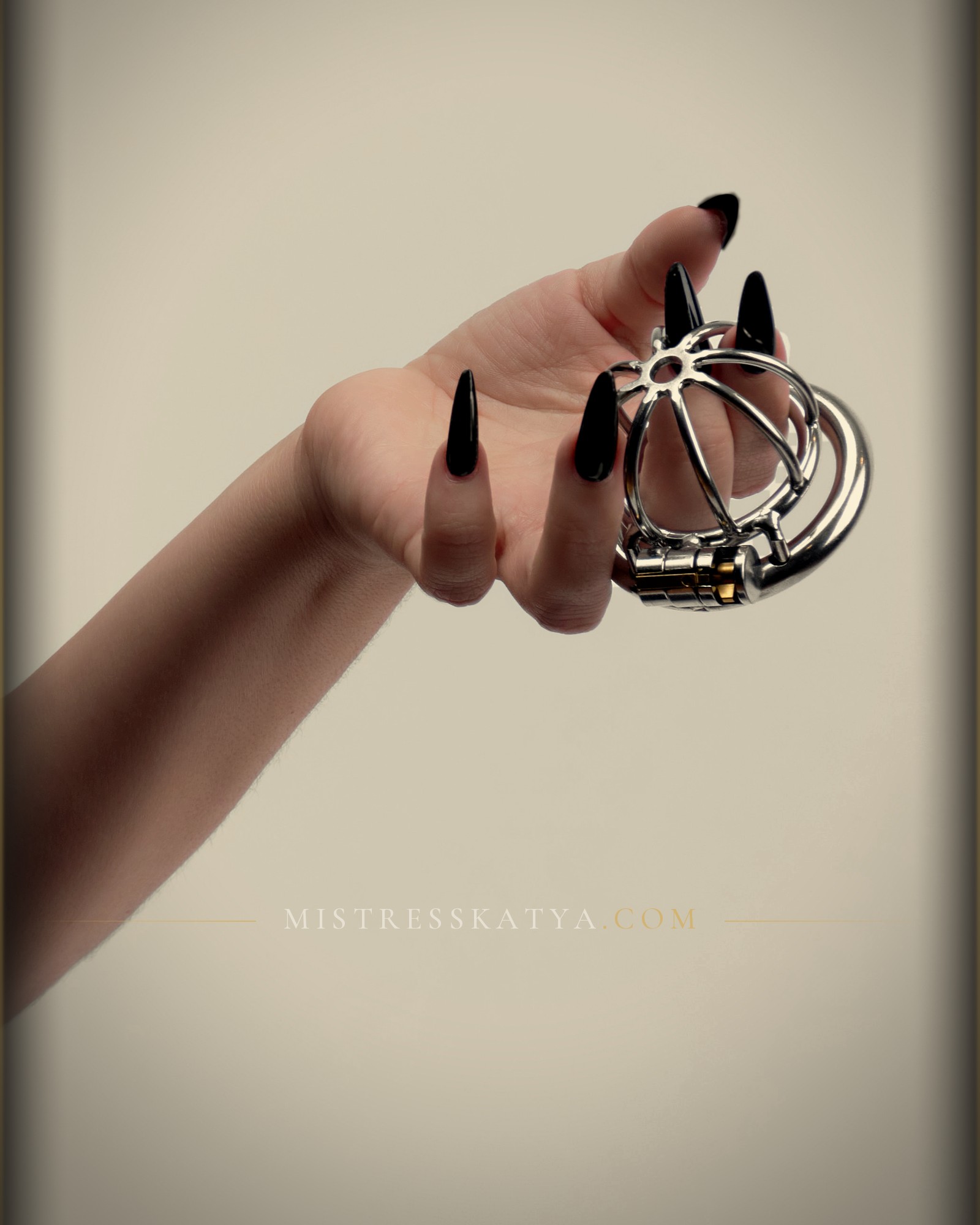 Chastity keyholder Sydney, Mistress Katya Green holding a locked chastity cage