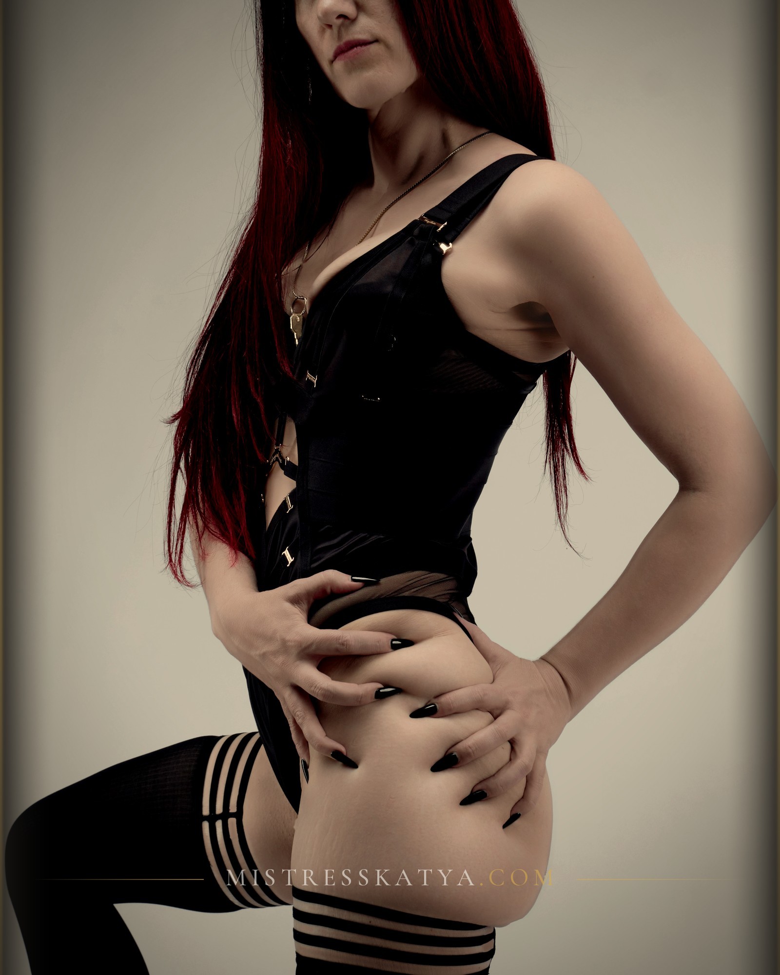 Sydney Mistress Katya Green in a black corset and stockings, Pro Domme Sydney